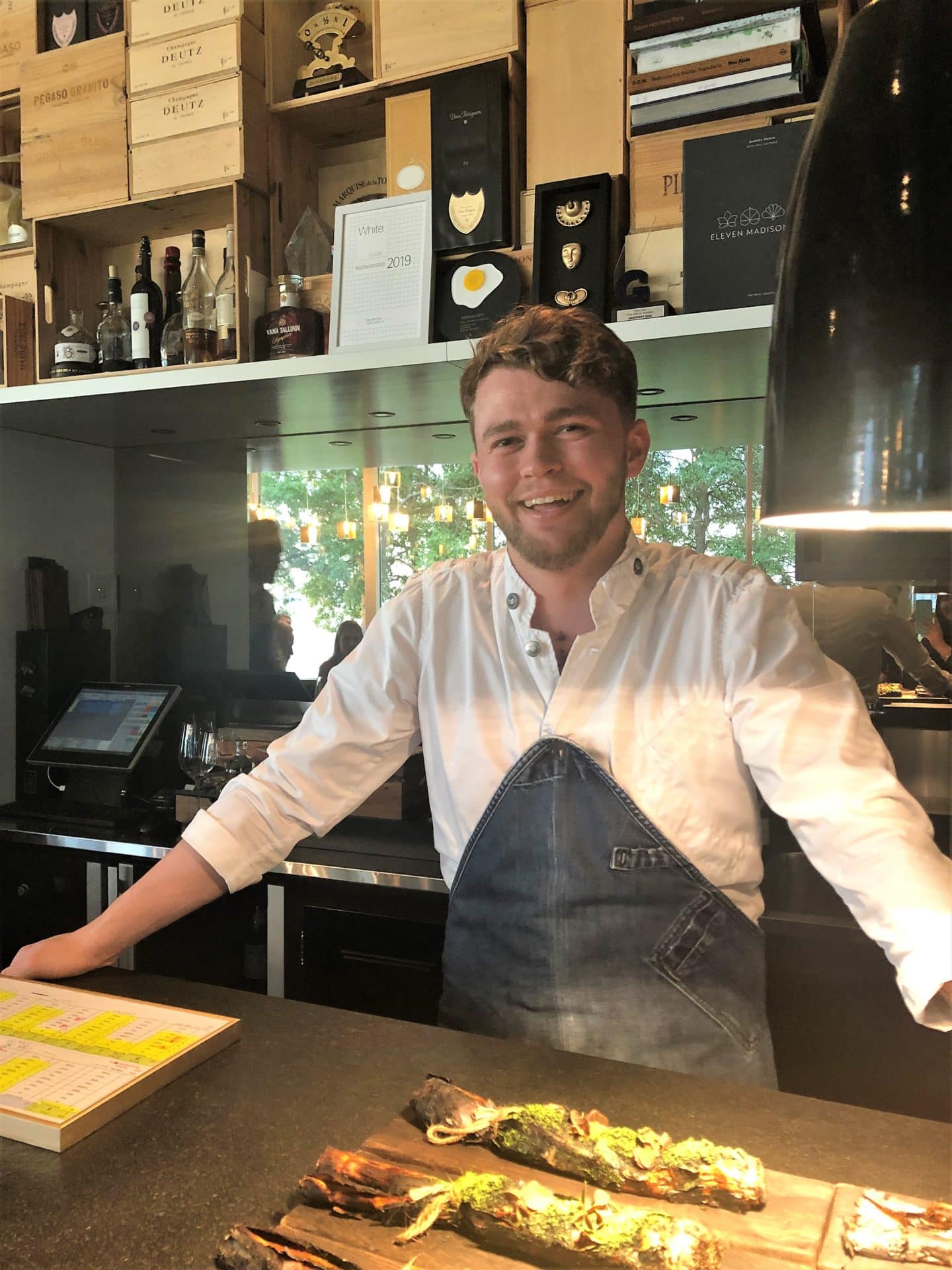 Chef Orm Oja standing with the charred leeks and truffle at Noa Chef's Hall in Tallinn