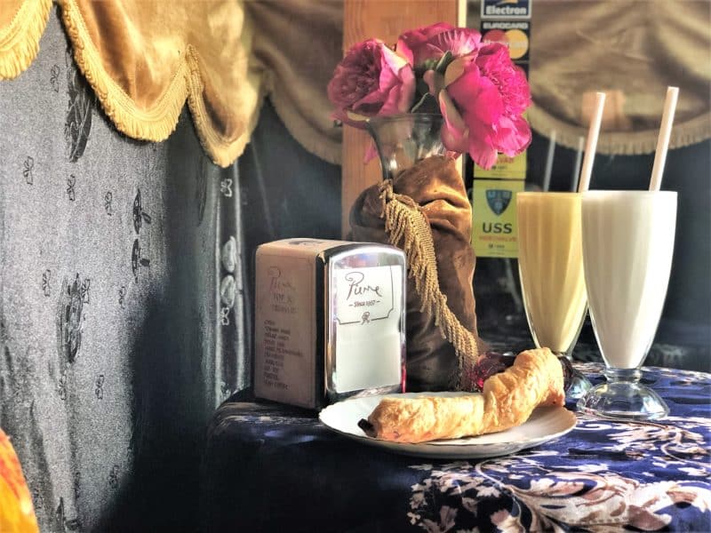 Milkshakes and cheese pastries at Pierre Chocolaterie, Tallinn under a blue and gold velvet table cloth