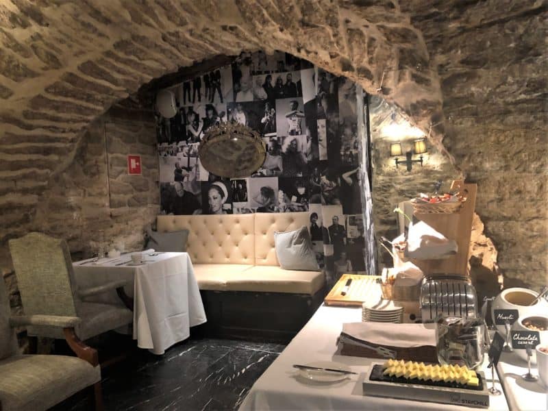 The Schlossle Hotel Tallinn: The Stenhus restaurant vaulted ceiling dining space with breakfast set-up and white and green seats