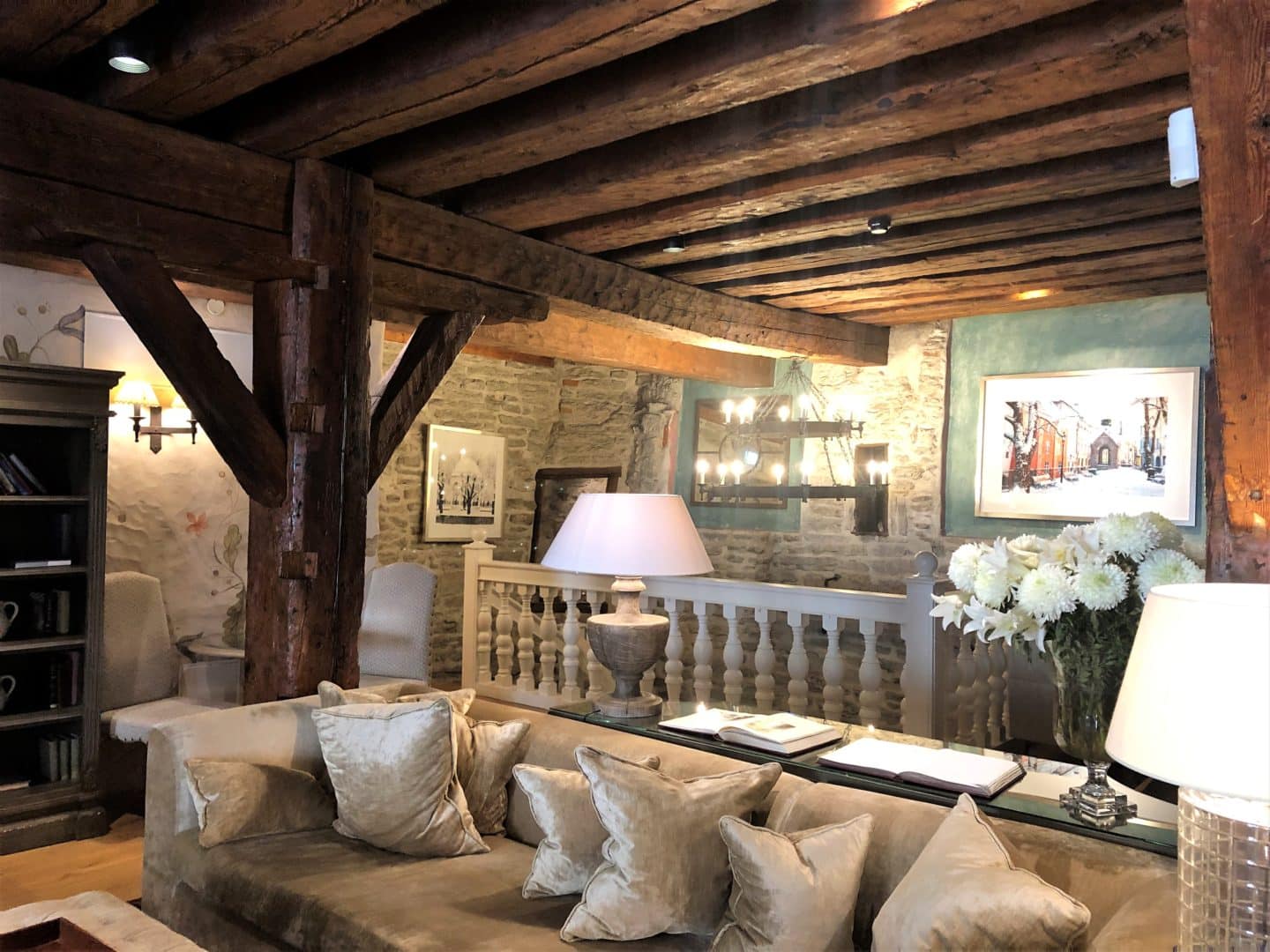 The Schlossle Hotel Tallinn: The lounge and lobby with beamed brown ceilings, a huge comfy corner sofa and stoned walls.