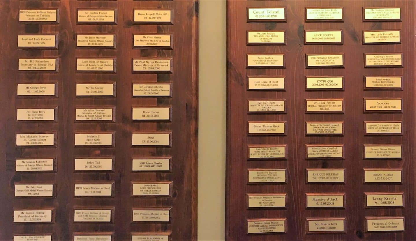 The Schlossle Hotel Tallinn: A list of gold plaques in a row on a wooden frame backing that has the names of all the VIP's that have stayed at the hotel