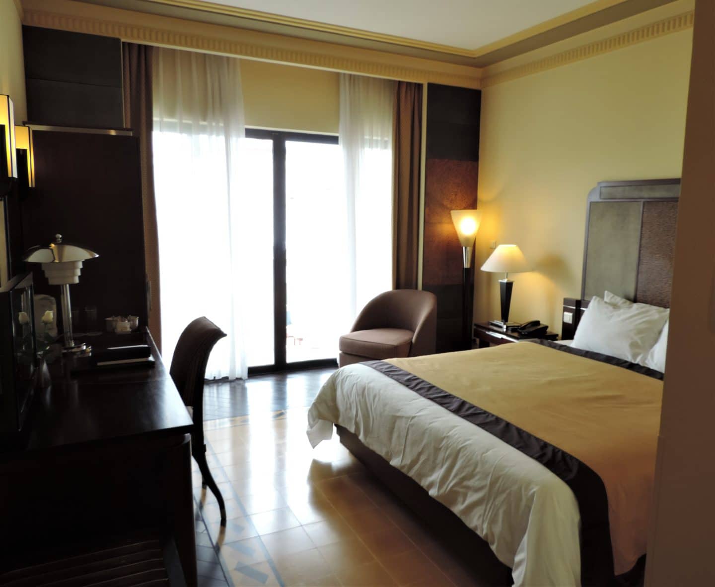 Azarai La Residence Hotel, Hue Deluxe room with dark wood and floor to ceiling windows