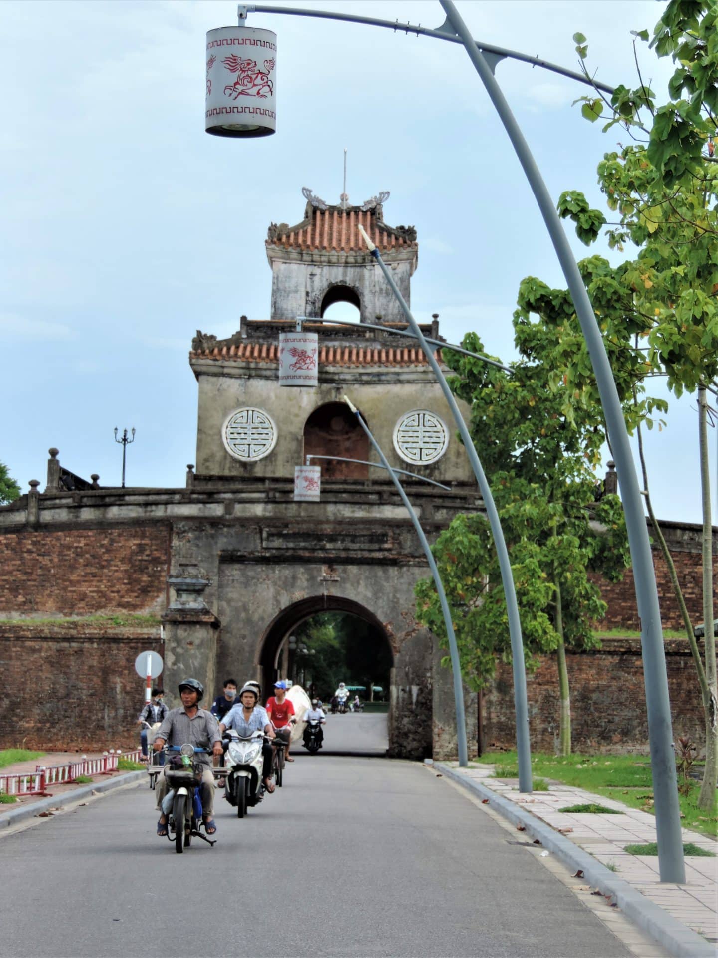 14 days in Vietnam : Hue Citadel Gate with motorbikes coming through the gateway