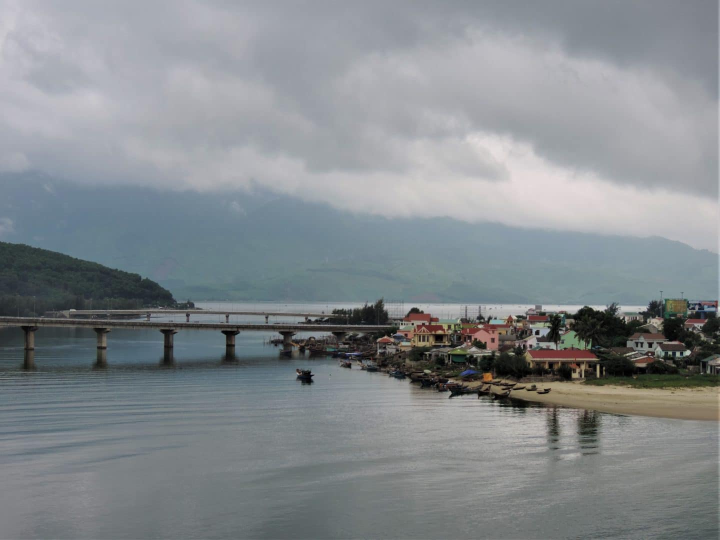 Da'nang scenes with the village and centre in the image surrounded by mountains and grey skies