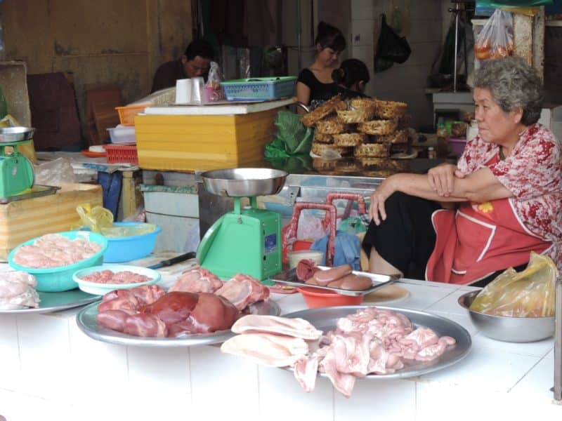 Ben Thanh Market, Ho Chi Minh City with a local meats vendor