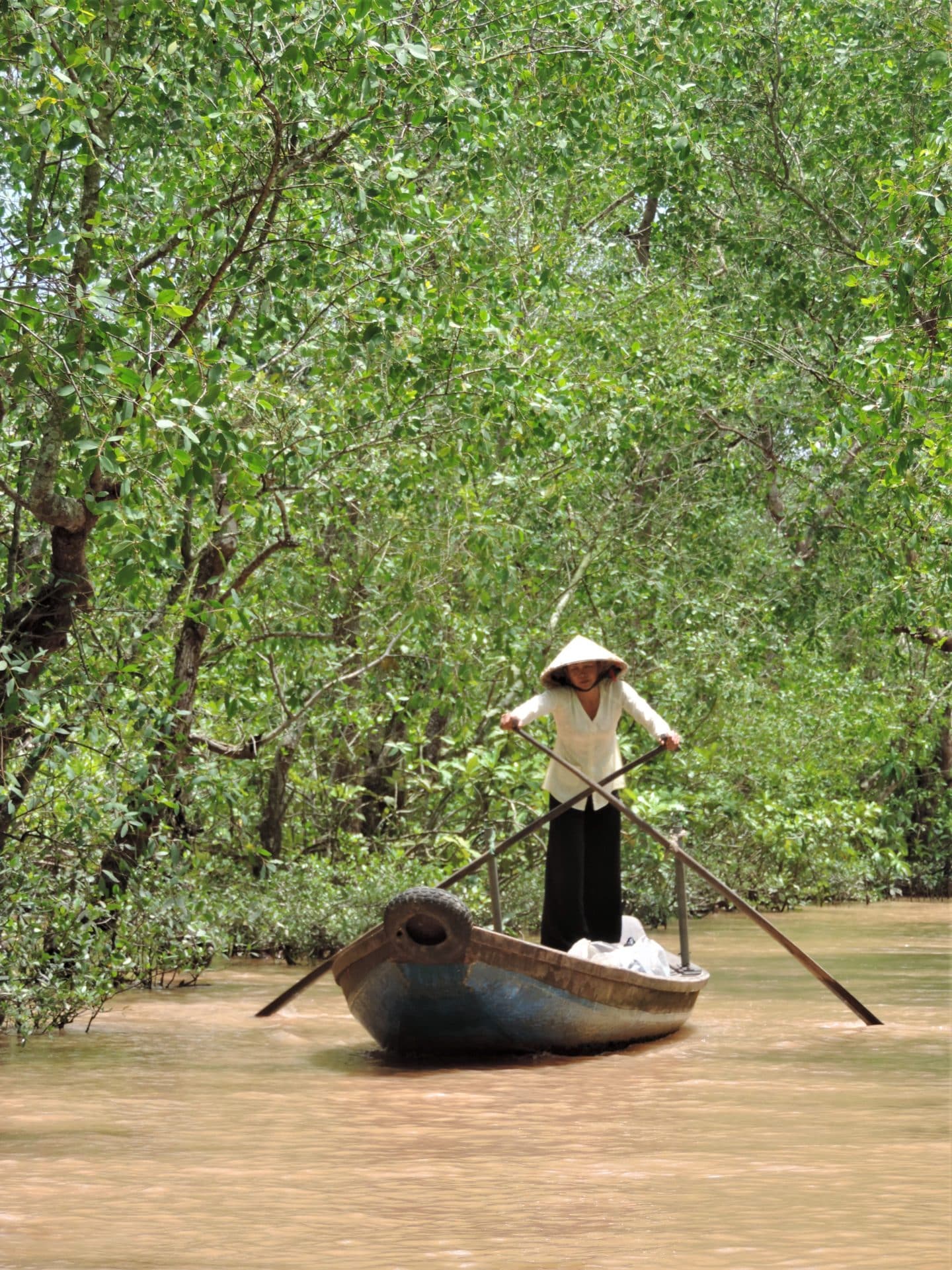 Vietnam in 14 Days: Mekong Delta cruise with a lady rowing her canoe along the river