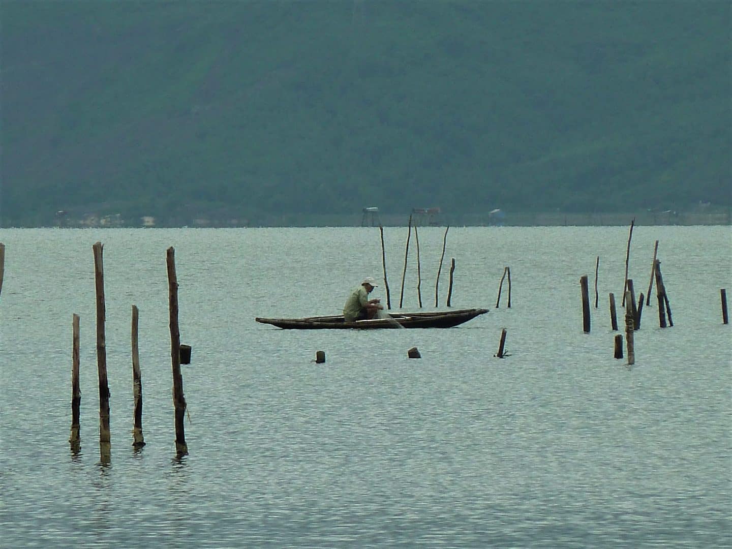 Shrimp Farm with fishermen in a small boat on the waters