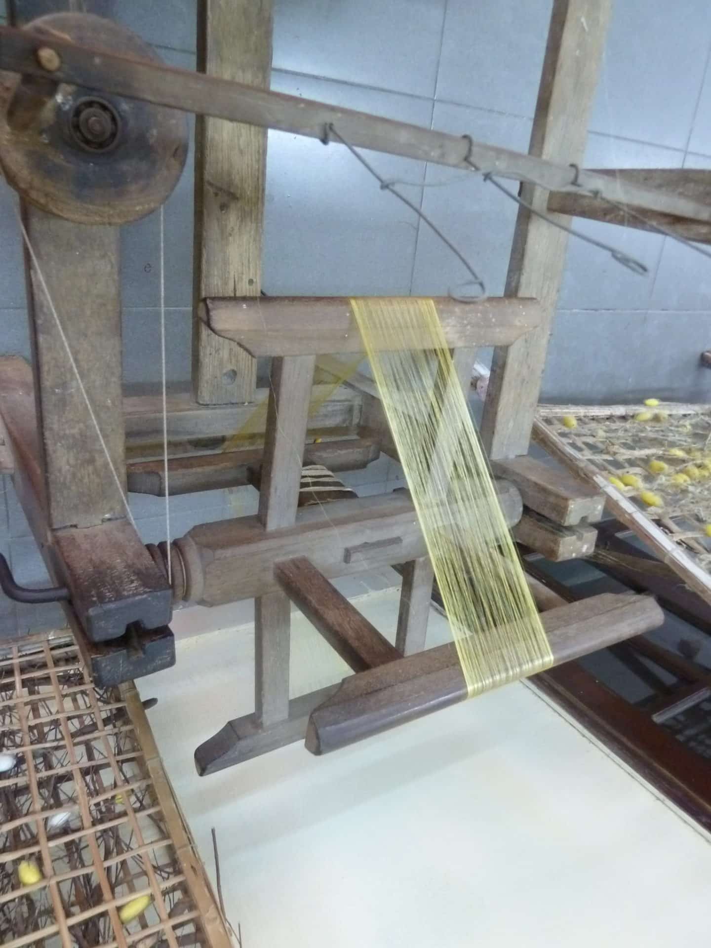 Making silk in Hoi An with hand weaving wooden machinery