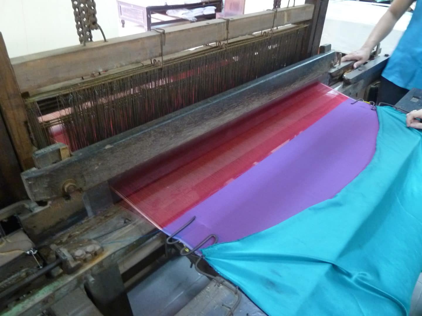 Silk being woven into different colours in Hoi An