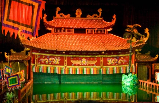 14 days in Vietnam: Thang Long Water Puppet Show stage with green, red and orange stage decor
