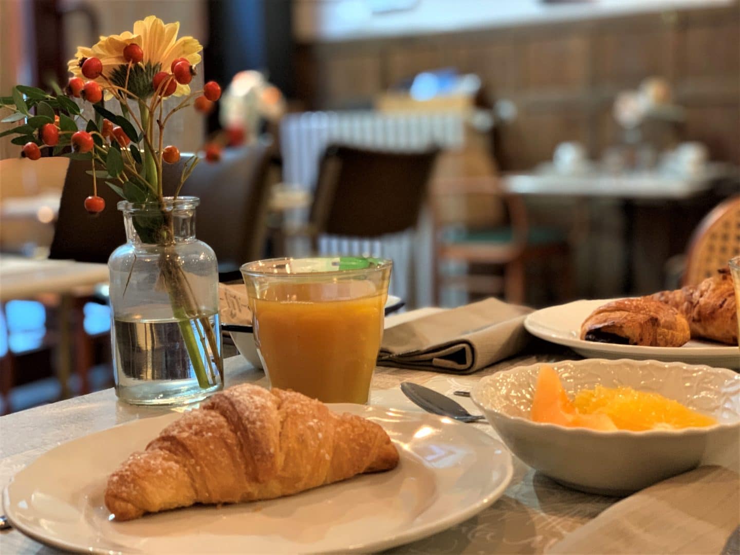 Croissant with glass of orange juice