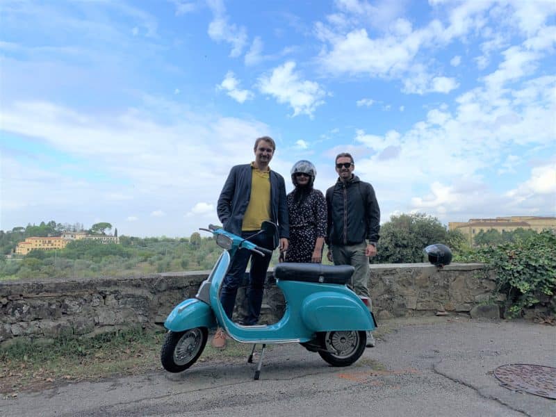 A Vespa tour from Florence to the Chianti Hills. Guides and Bejal standing in front of the scooter