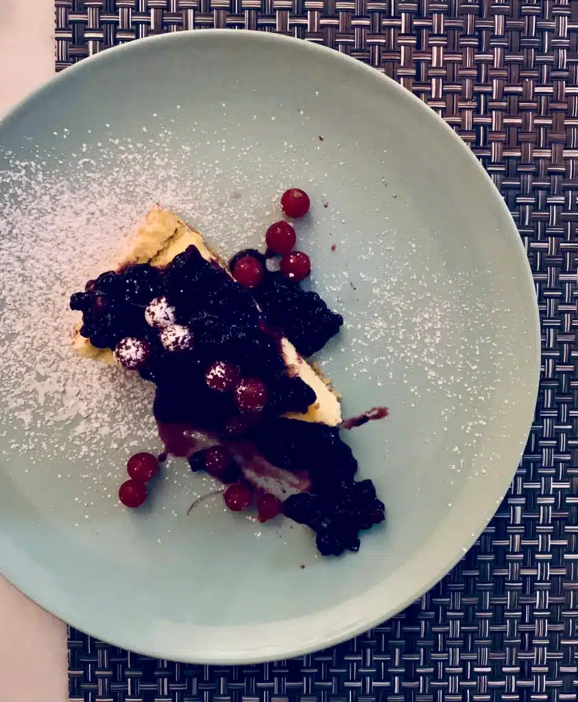 Vegetarian-friendly food in Florence, a slice of chocolate cake topped with berries and fruit