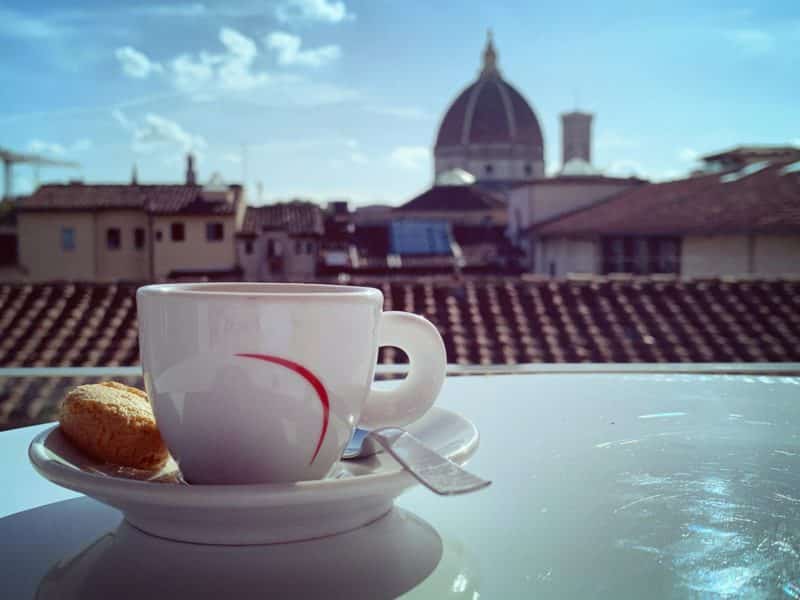 The views of the duomo out of the windows of Caffè del Verone. A cup of coffee frames the picture
