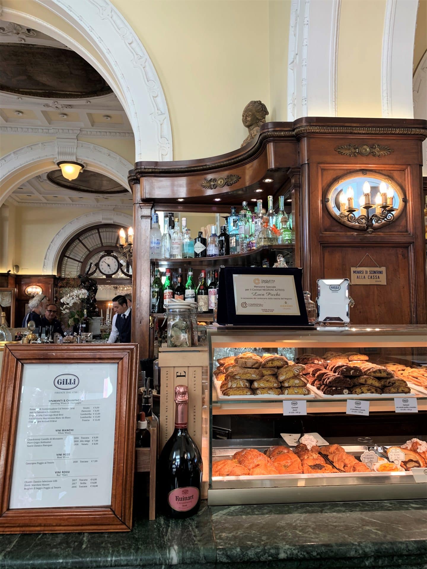 Vegetarian-friendly food in Florence. The interior of Caffè Gilli with the counter full og sweet treats and a menu