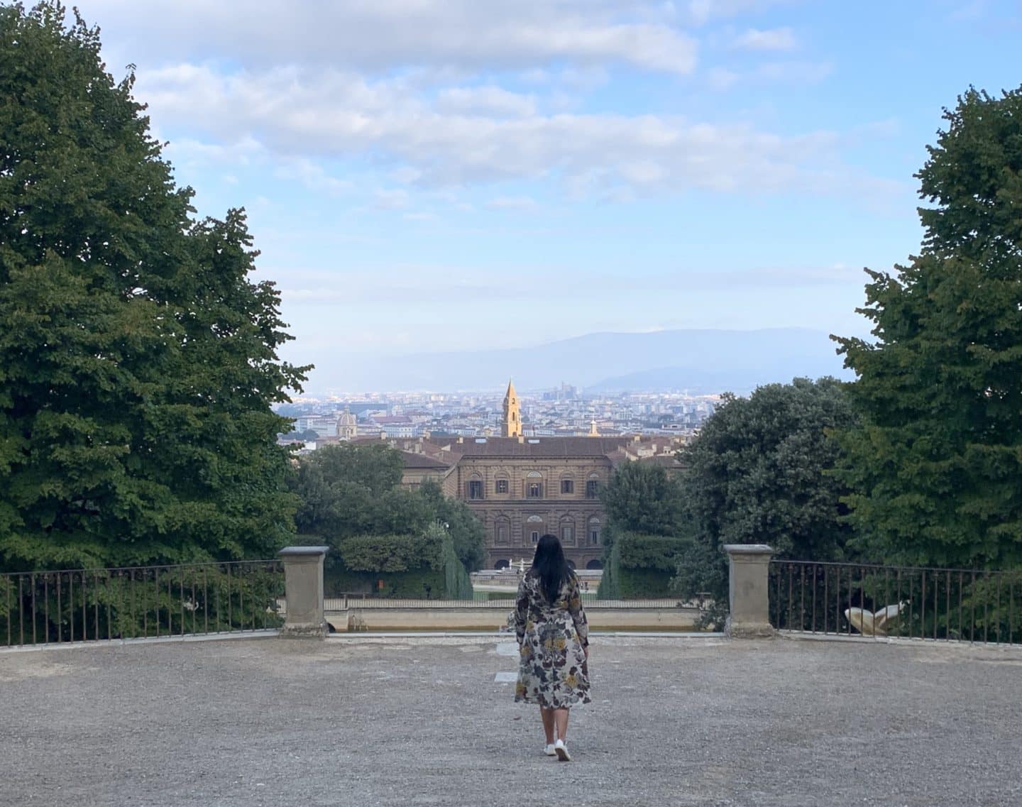  Oltrarno An Artisanal Neighbourhood in Florence: bejal walking down Boboli Gardens with Florence skyline in the background