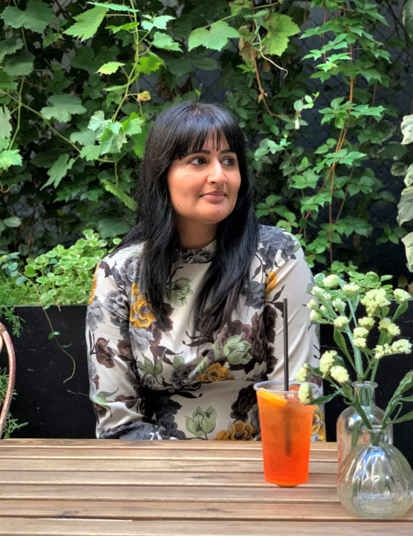 Serre Torrigiani in Piazzetta - Bejal sitting with autumnal dress drinking a glass of Aperol Spritz.