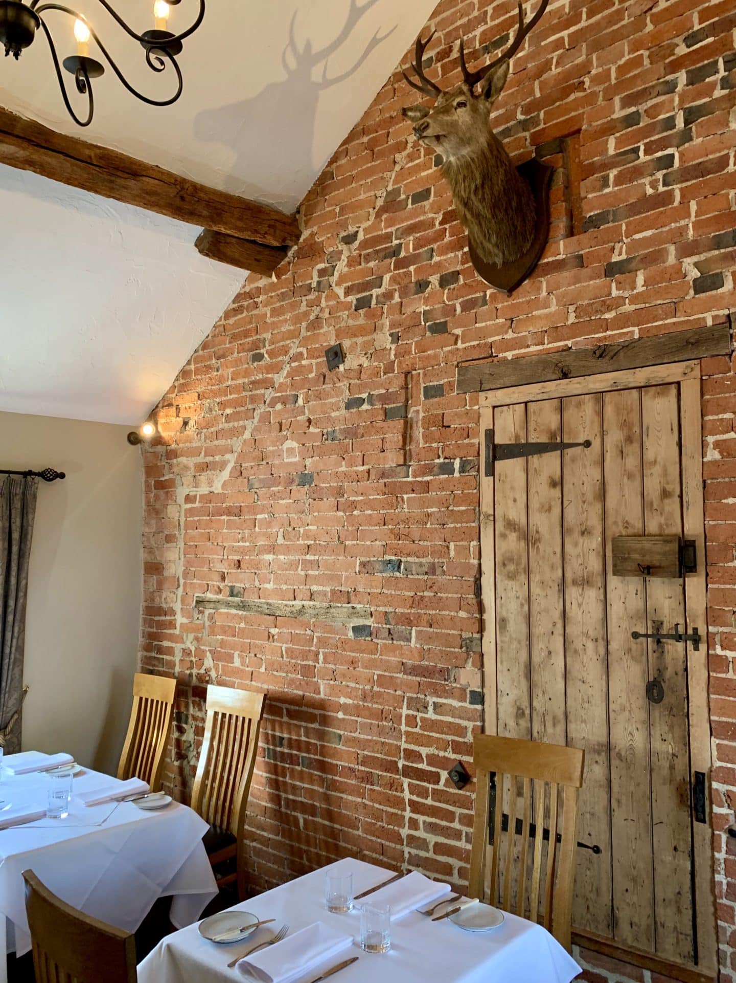 Brick wall and seating area at John's House restaurant upstairs. 