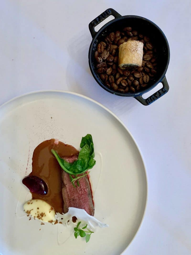 A flat lay of teh Roast Fallow Deer, cauliflower, Red Cabbage Ketchup and Coffee with a Moroccan spiced Pastry