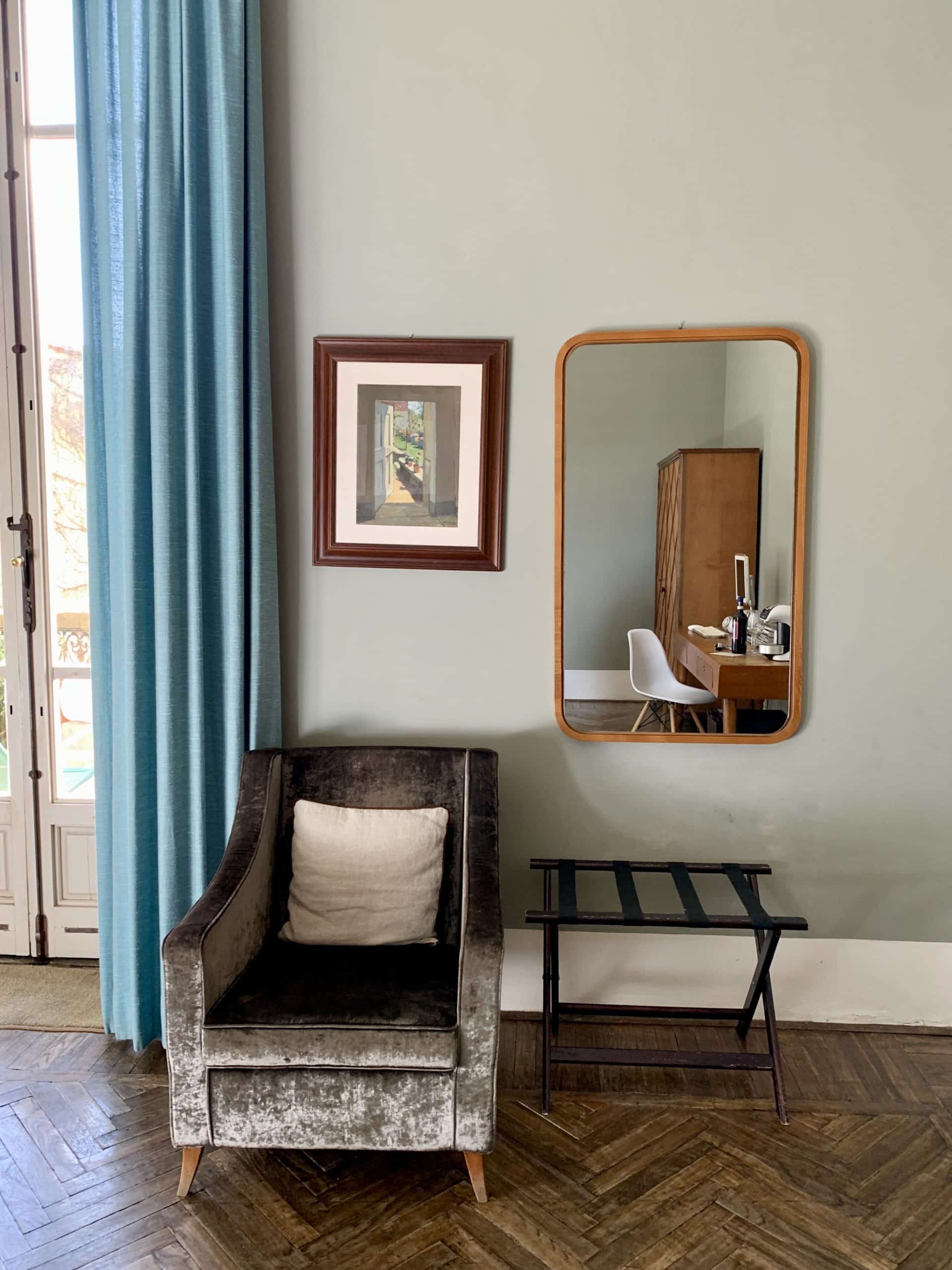 Armchair in suite with mirror and parquet flooring