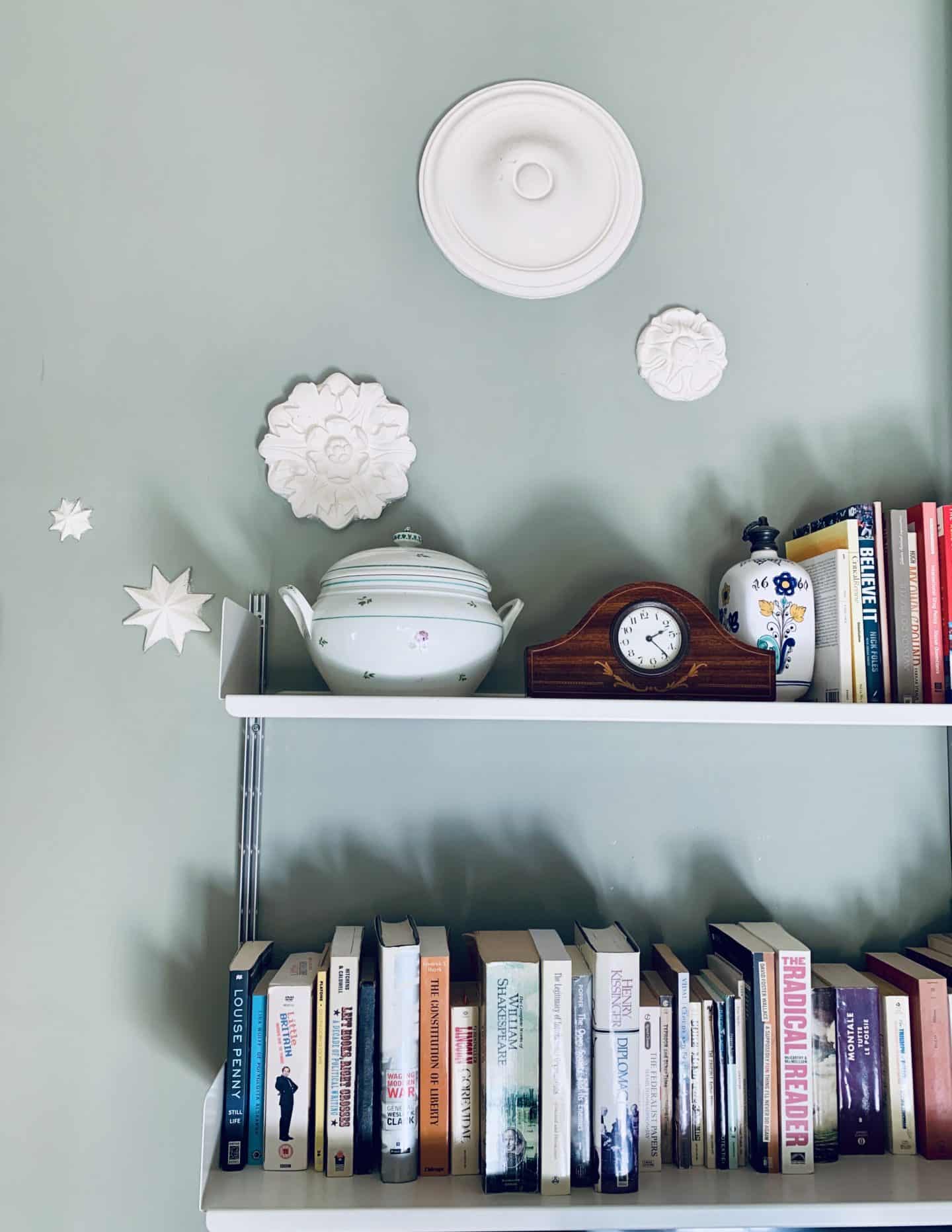 Shelves with books and artefacts on the walls