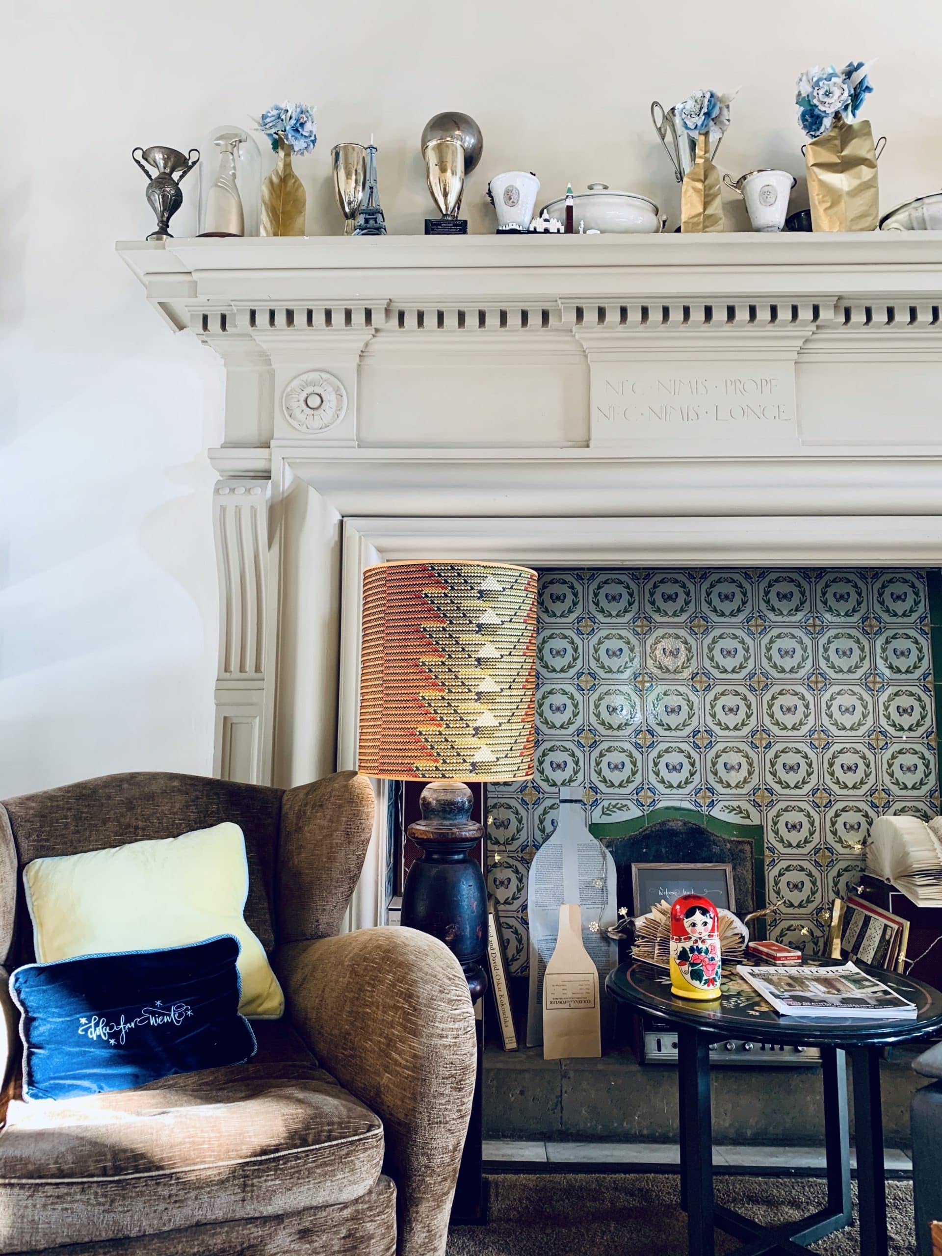 AdAstra Florence armchair with eclectic fireplace and curios