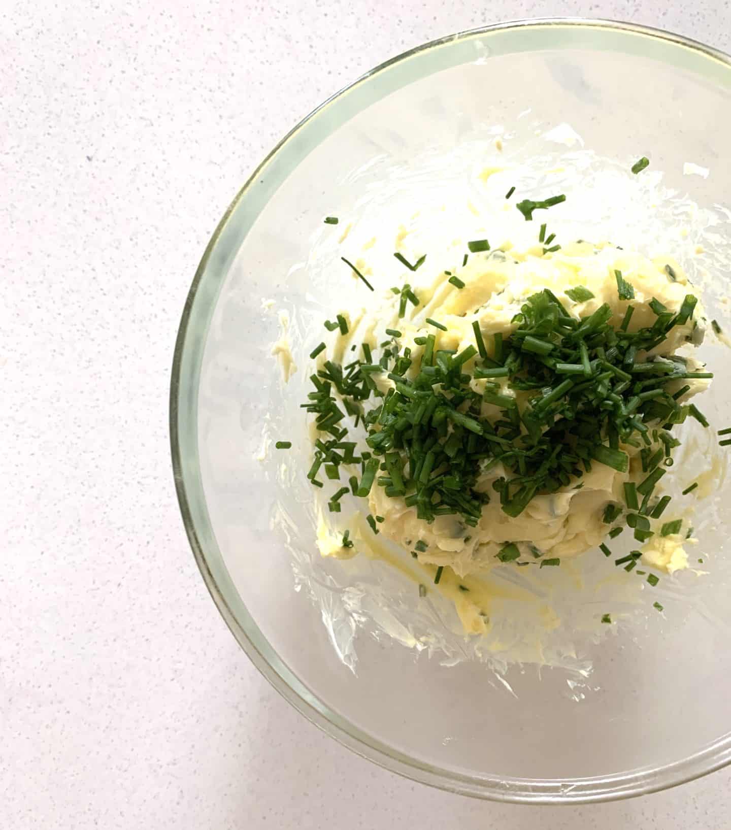 Melted butter, chives and salt in a bowl