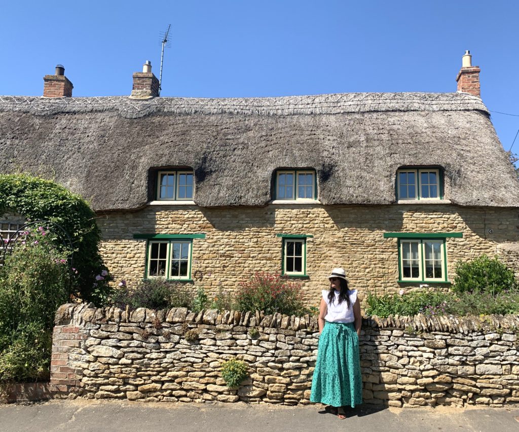Bejal standing outside cottages