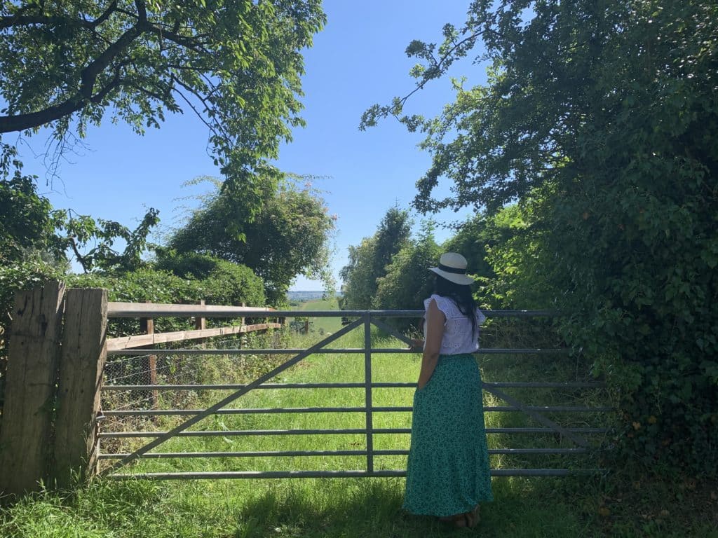 Bejal standing at field gate