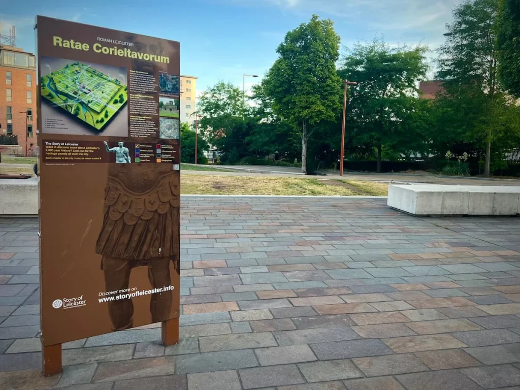 Story of Leicester Ratae Corieltavorum Board. The board in dark maroon in colour and is on Jubilee Square in Leicester. Part of the locals guide to Leicester
