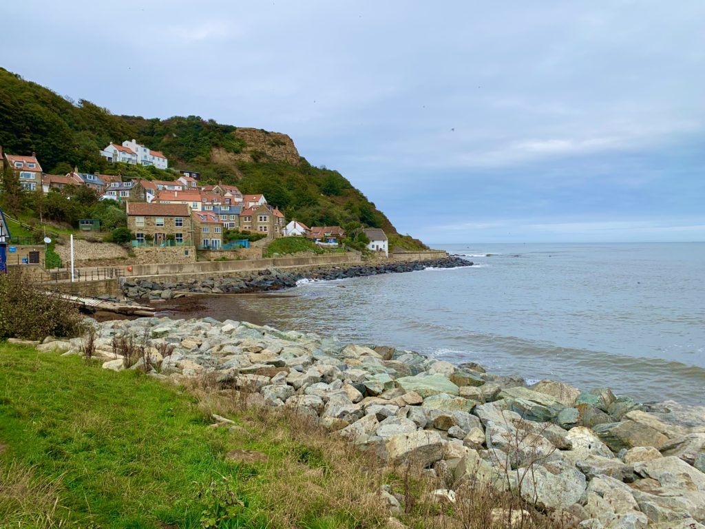 Runswick Bay Coastal village with rocks and houses in th ebackground