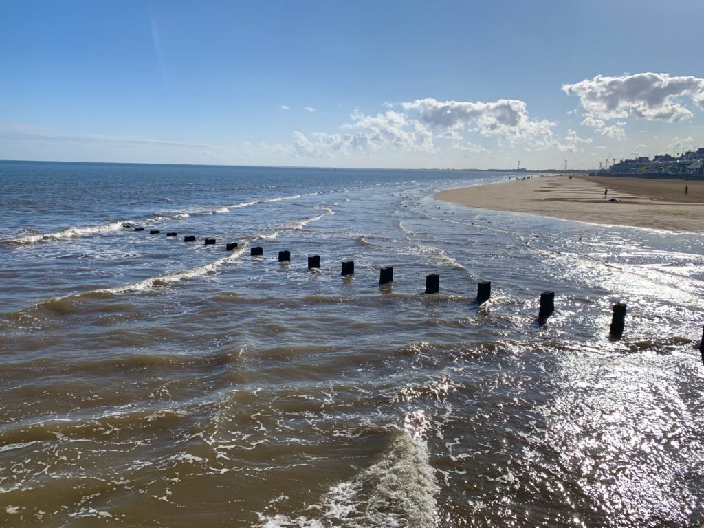 Bridlington beach when the tide is out and people in the background on the golden sand