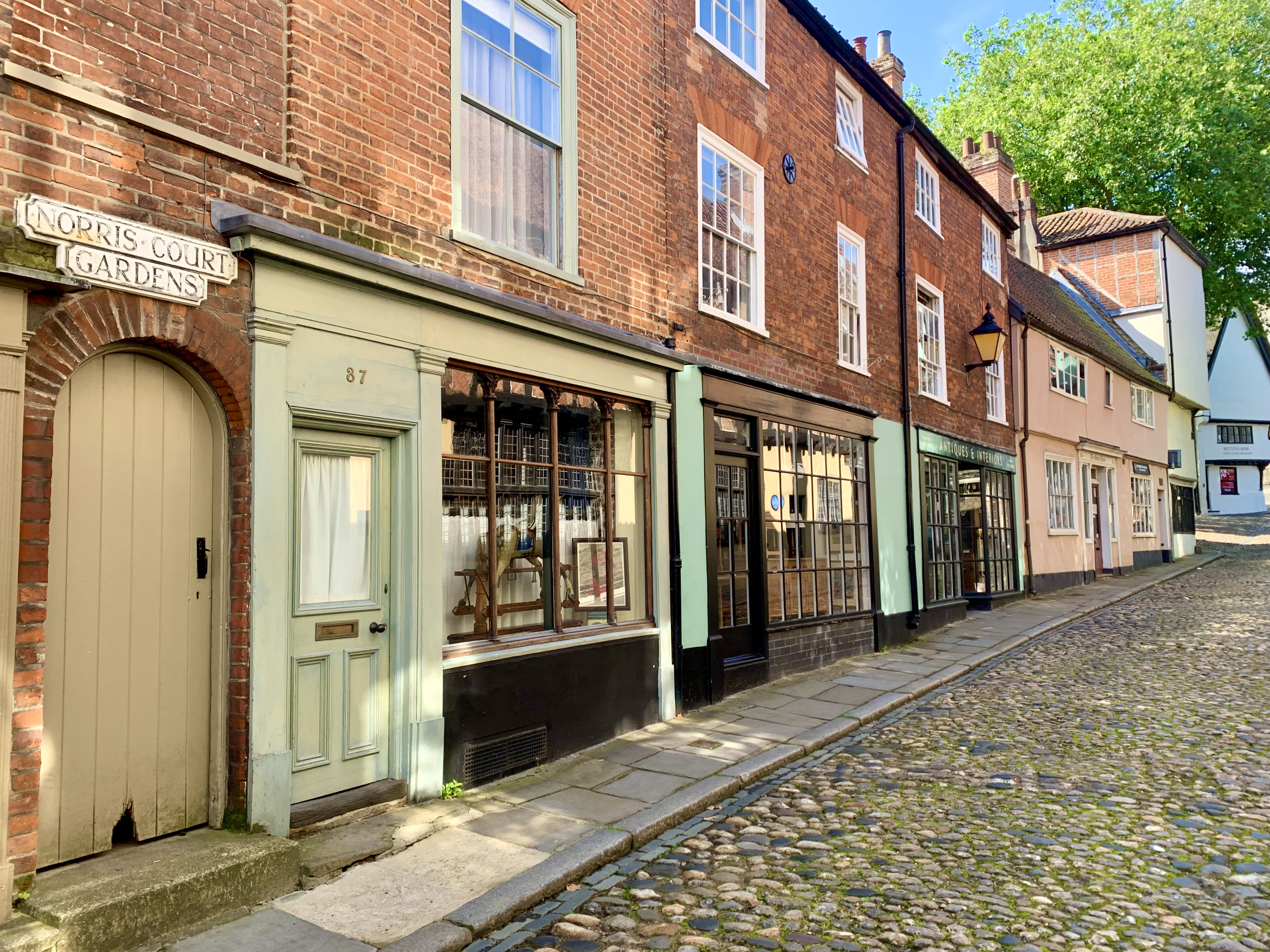 The colourful lined houses of Tombland of Norris Court Gardens with cobbled-stone roads.