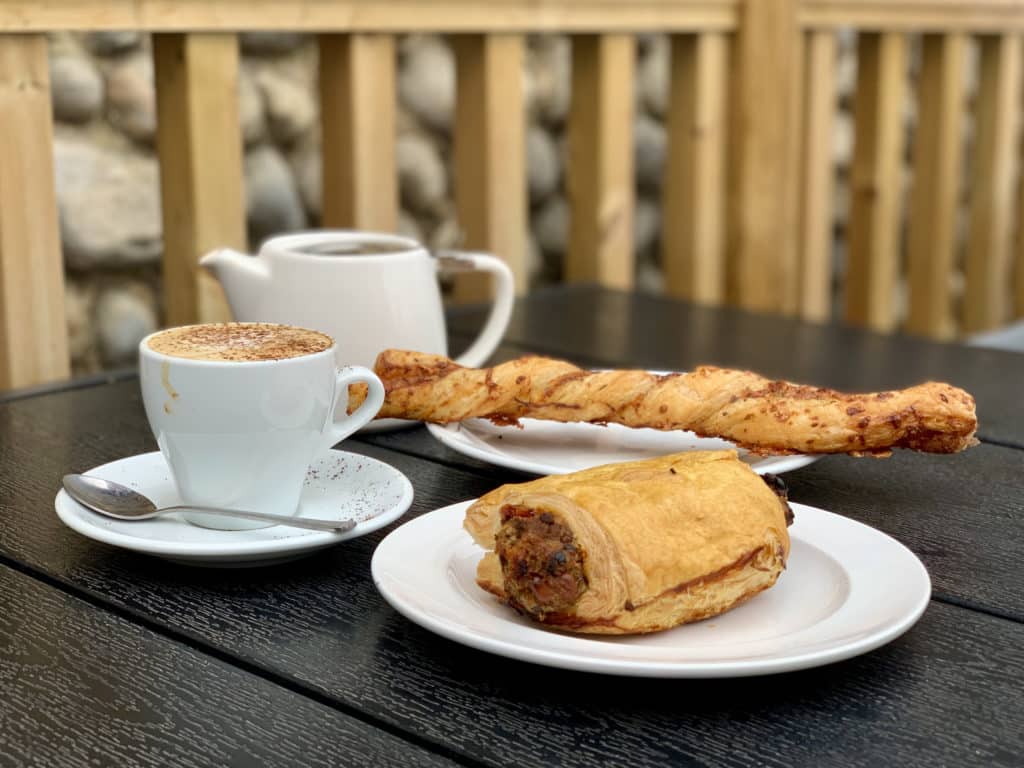 flaky cheese twist or Moroccan pastry, washed down with a cappuccino at The Two Magpies cafe in Blakeney, Norfolk