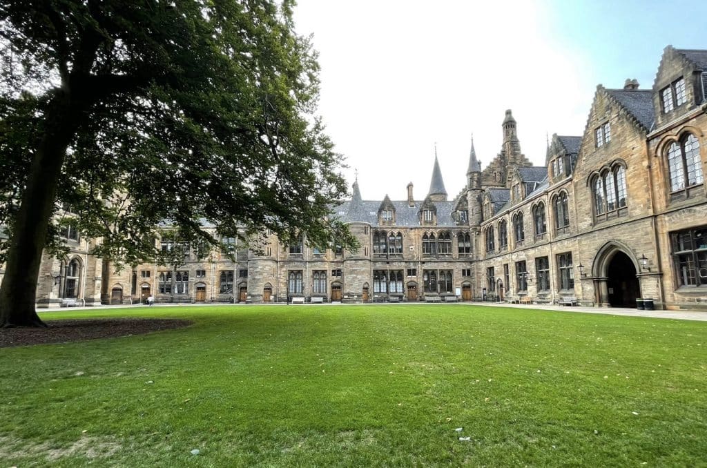 48 hours in Glasgow: Exterior of the Glasgow University Cloisters with lawn in front and trees to the side