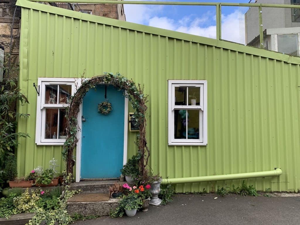 48 hours in Glasgow: One of the cute buildings on Hidden Lane with a blue door and lime green exterior