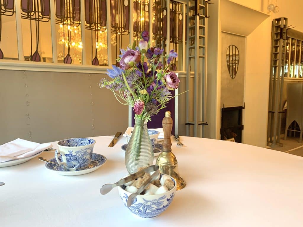 48 hours in Glasgow: The Mackintosh at The Willow Tearoom table display featuring brown and white sugar cubes, wild floral display and china teacups.