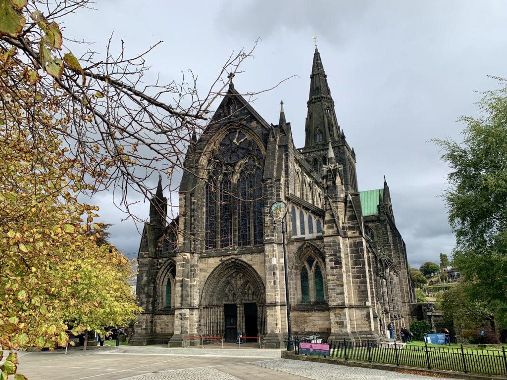 Glasgow Cathedral exterior with trees and foliage on either side of the front entrance