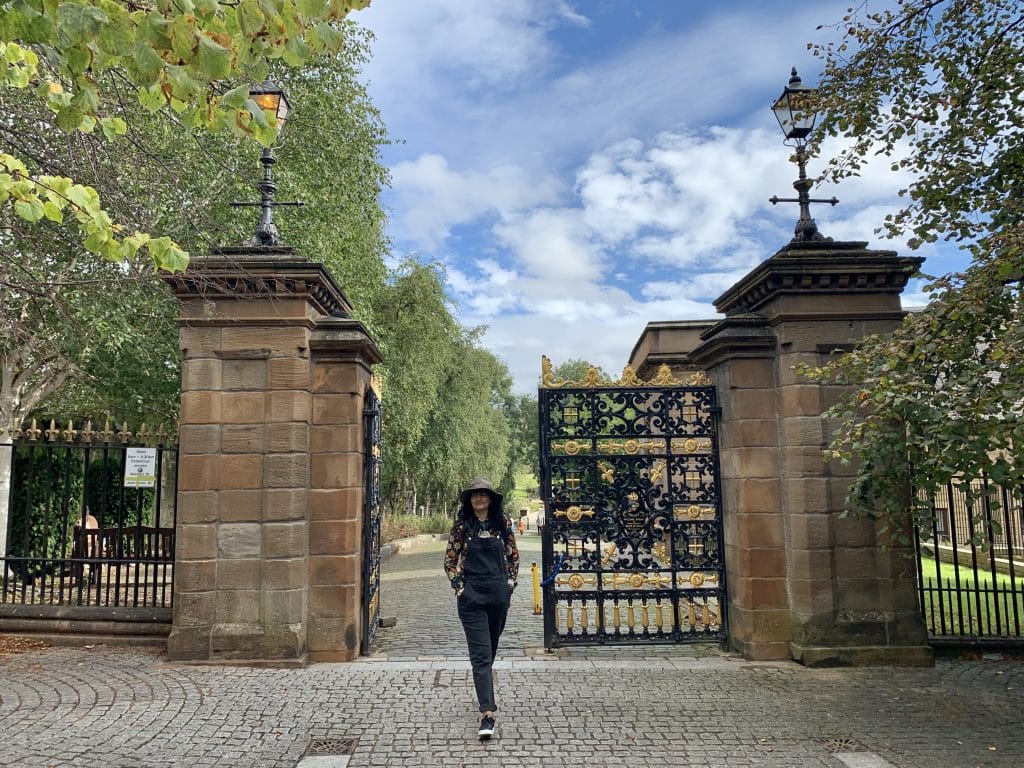 Bejal walking through the entrance gates at Glasgow Necropolis