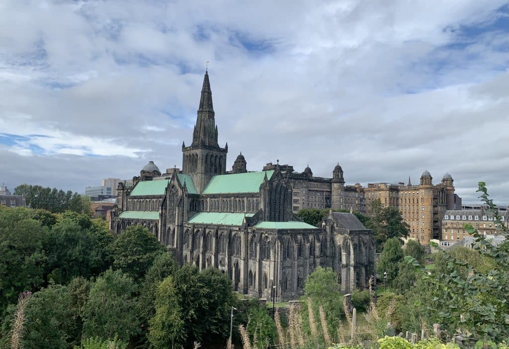 Views from the Glasgow Necropolis of Glasgow Cathedral surrounded by trees and older buildings