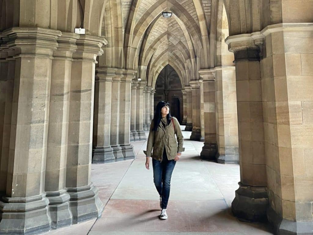 Bejal walking through Glasgow University Cloisters 