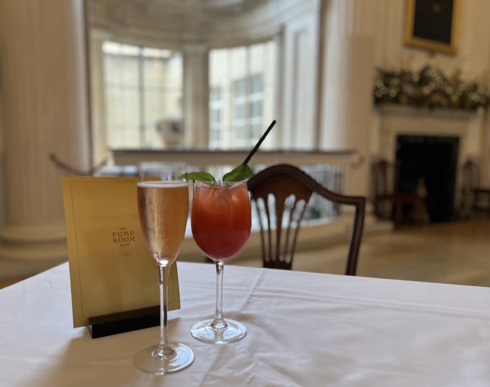 A glass of champagne and a non-alcoholic cocktail Afternoon Tea at The Pump Room in Bath. 