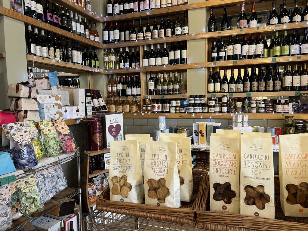 Chandos Deli in Bath. There are jars of conserves, sauces, packets of crostini and bottles of wine on the shelves in the deli.