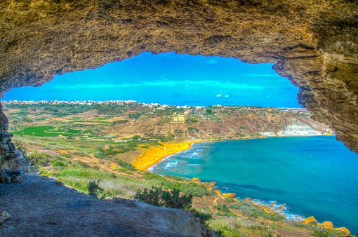 Aerial view of Ir-Ramla bay at Gozo through the Tal-Mixta Cave, Malta