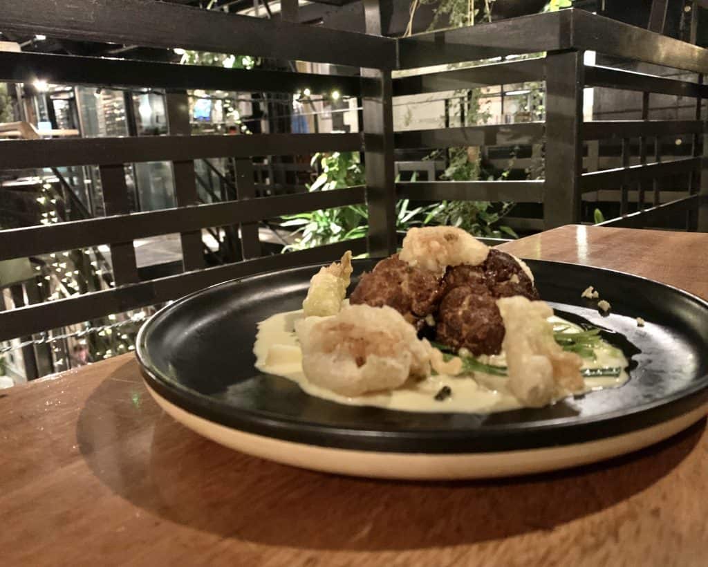 Vegetarian Food in Scotland, The Ubiquitous Chip. A plate with veggie haggis and cauliflower cooked 3 ways