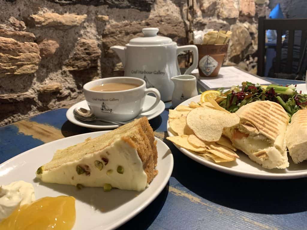 Vegetarian Food in Scotland: Crail Tearooms & Art Gallery. Tea pot with teacups, paninis with crisps and salad and a slice of cake