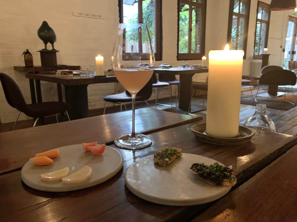 Timberyard, Edinburgh with amuse bouche and orange wine with a candle. Located in Edinburgh