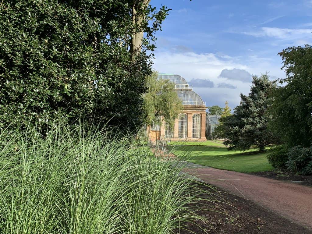Edinburgh Royal Botanical Gardens greenhouse building with foliage covering its exterior