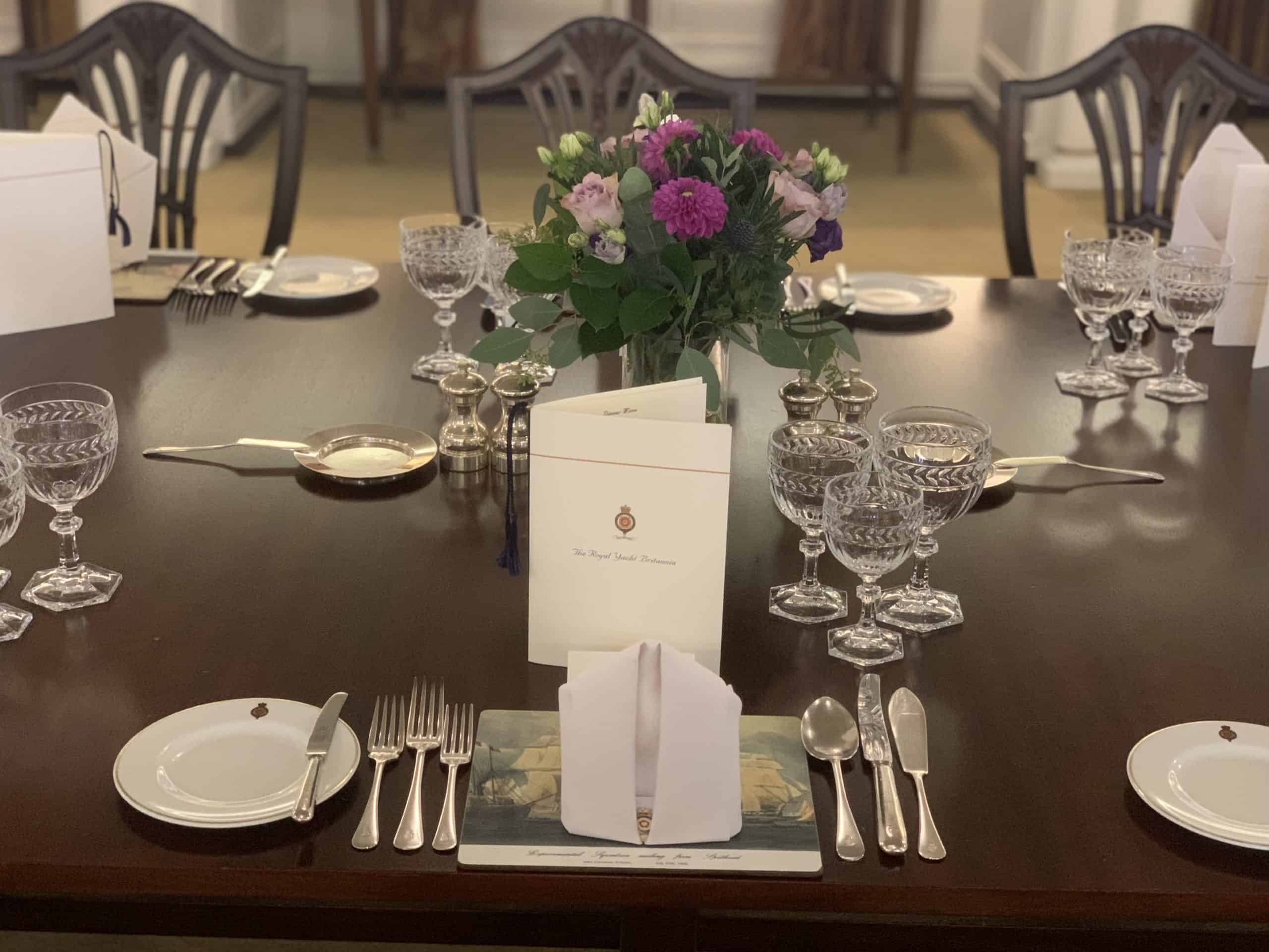 The Royal Yacht Britannia Dinner States room table setting with silverware and crystal glassware in Edinburgh