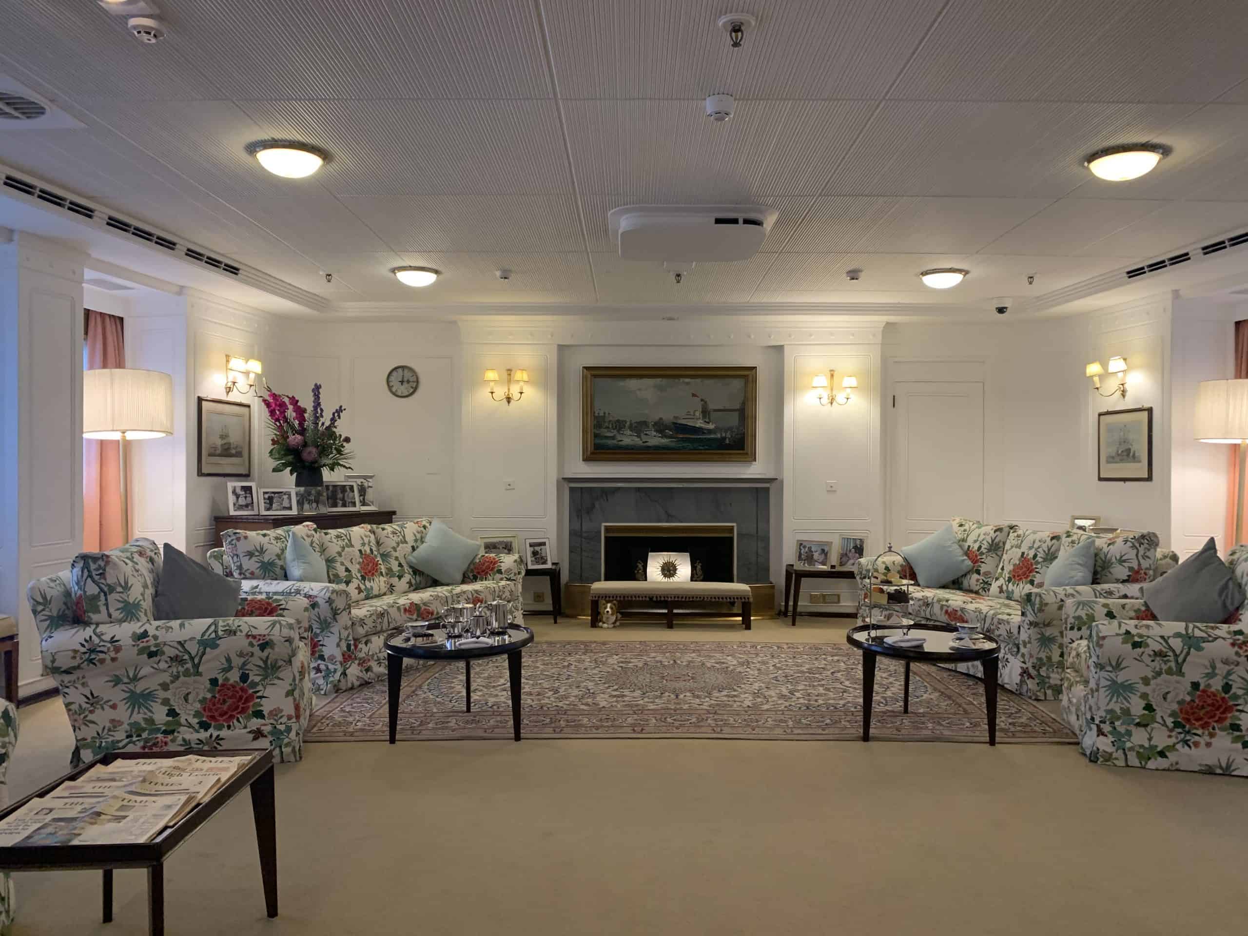 The Royal Yacht Britannia Lounge with floral sofas and a fireplace, Edinburgh
